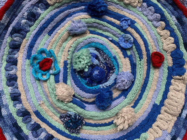 circular rug made from knitting doll yarn in spiral form
