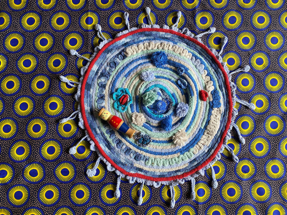 knitting doll rug on sun-background