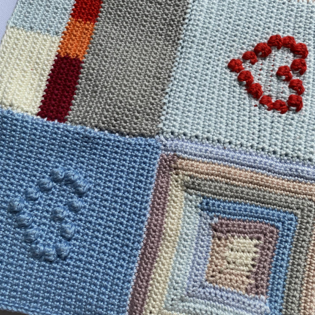 4 granny squares with hearts and log cabin pattern sewn together