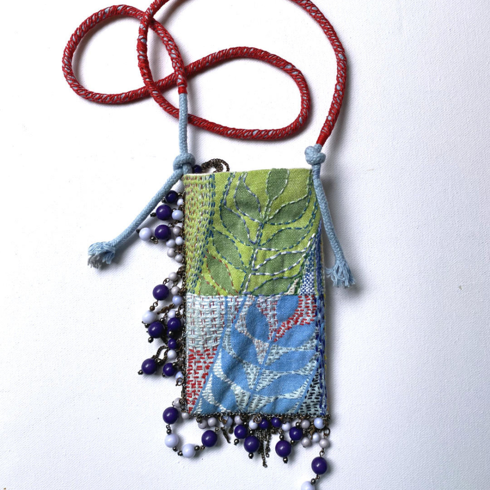 embroidered phonecase with pearl necklace and cord