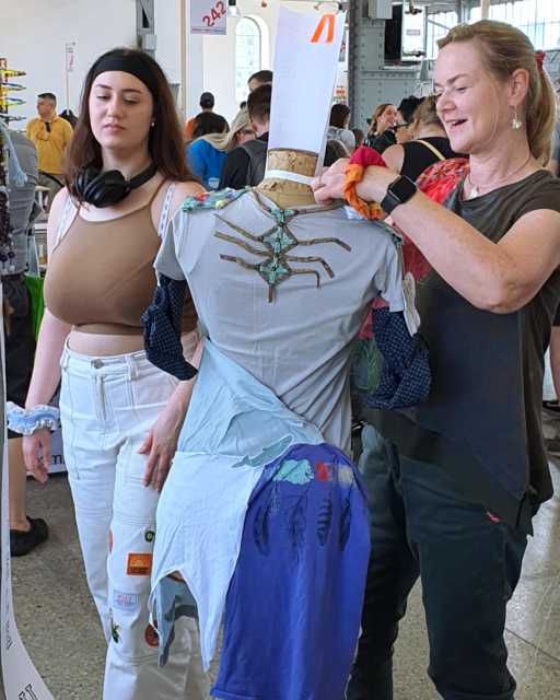 woman and her daughter making a dress on the mannequin