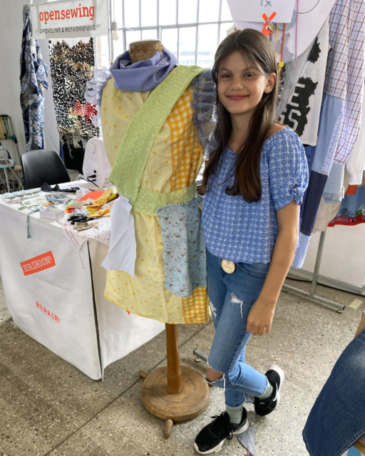 Nina with finished colorful dress on mannequin