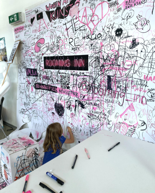 girl drawing in booth of rooming inn