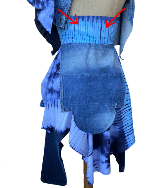 lower part of dress from backside with red arrows