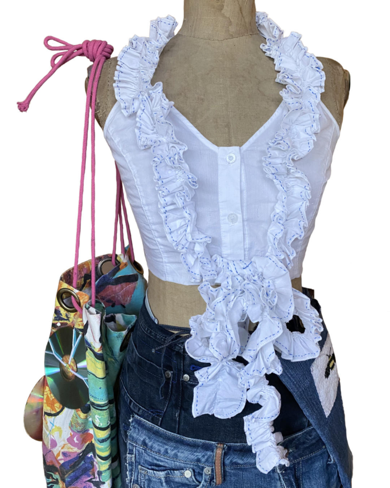 ruche top with a front bow on a mannequin with a colorful tote bag